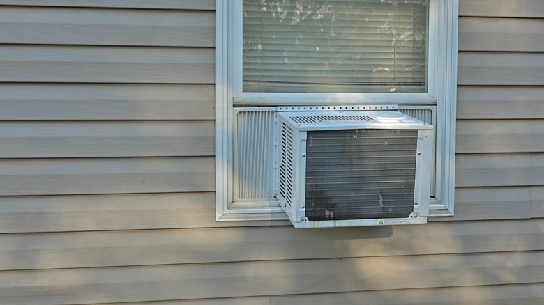 Small air conditioner on the exterior of a house's window
