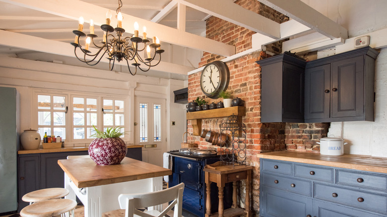Chandelier in kitchen with wood and blue accents
