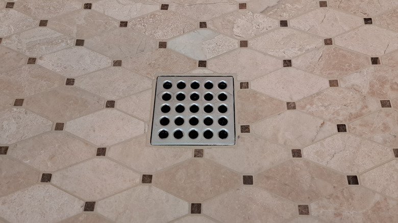 Close-up of a floor drain on a tiled floor