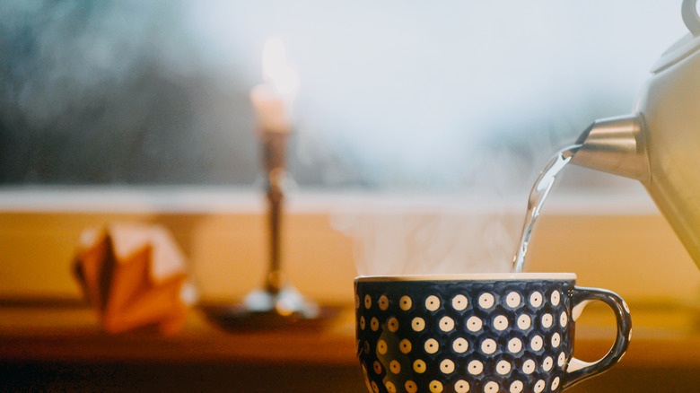 pouring hot water in cup