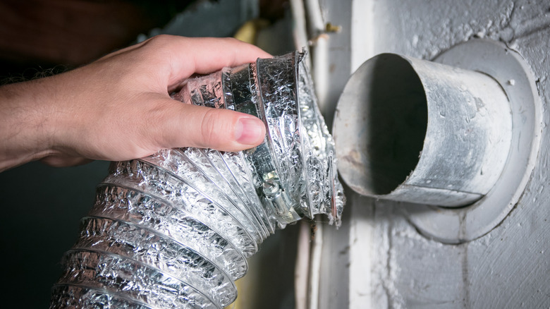 Person removing dryer vent tubing