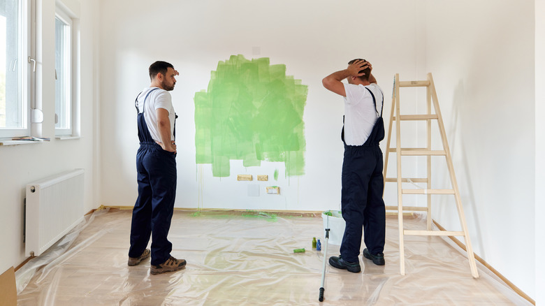 men looking at bad paint job