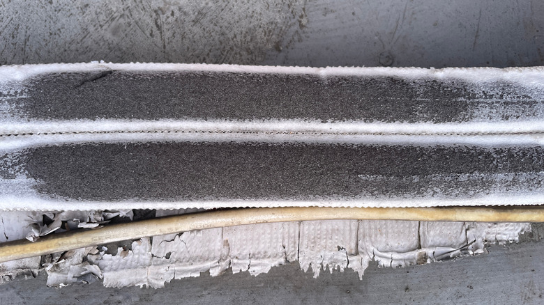 Close up of the damaged surface of the AC water pipe.
