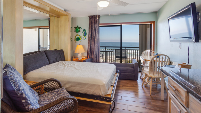 A small room makes use of the space with a Murphy bed