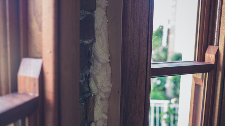 Expanding foam around a window in an older home