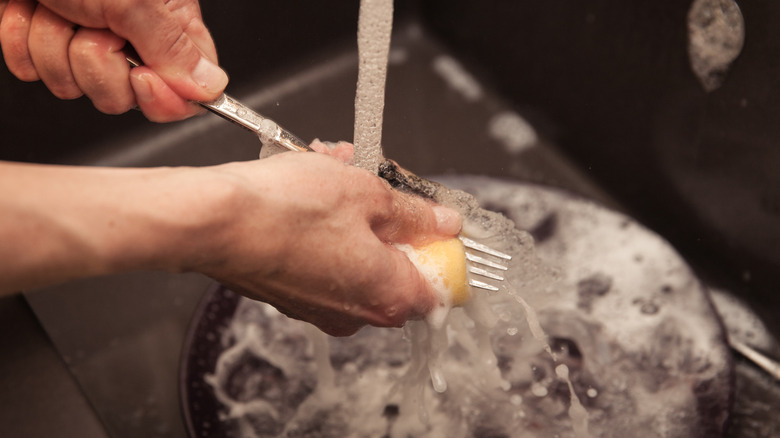 Washing forks in sink