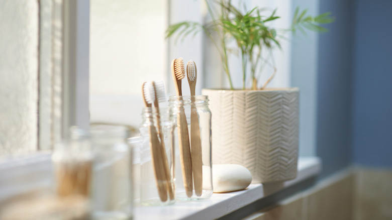 Wooden toothbrushes on window sill