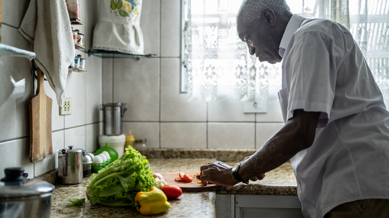 A person is cutting vegetables on a cutting board