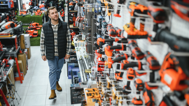 A man choosing from a wide array of power tool options