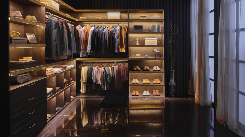 A chic, organized closet full of men's clothes
