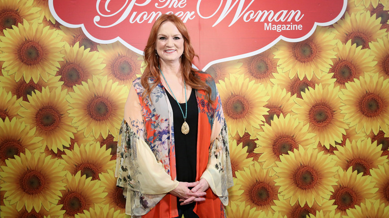 Ree Drummond appears in front of a backdrop for The Pioneer Woman Magazine