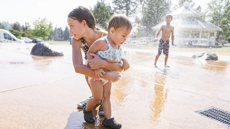 kids at a splash fountain on a hot summer afternoon