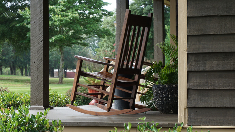 A wooden rocker on a porch