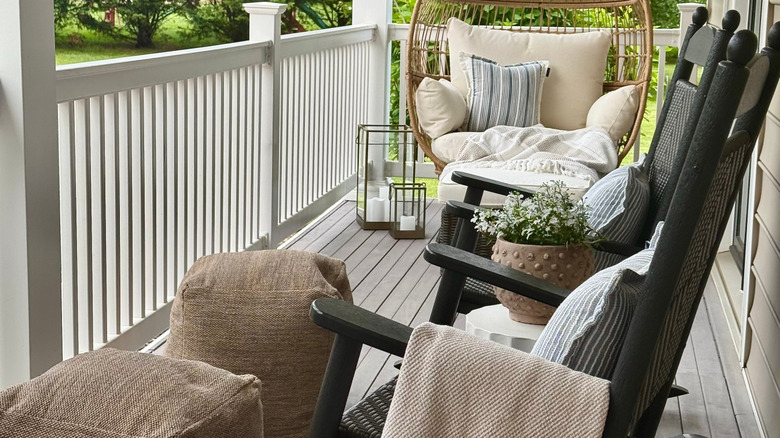 Black rockers on a porch with trendy decor