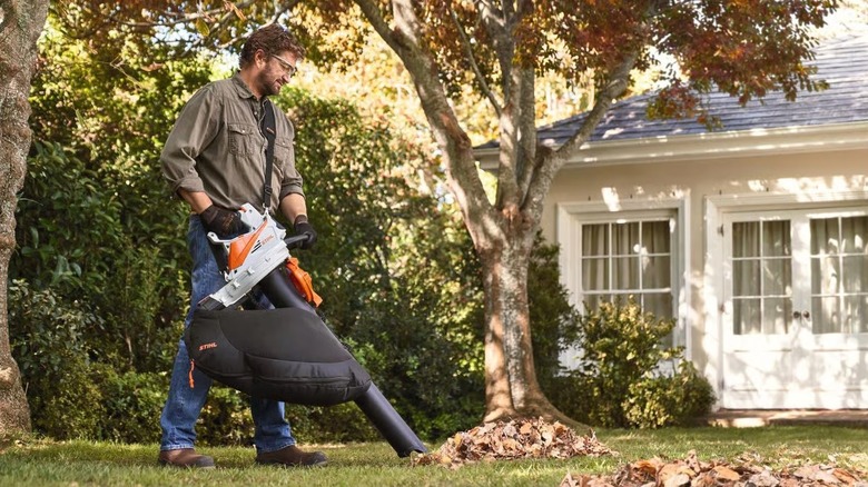 Man using a Stihl battery-powered leaf vacuum and mulcher