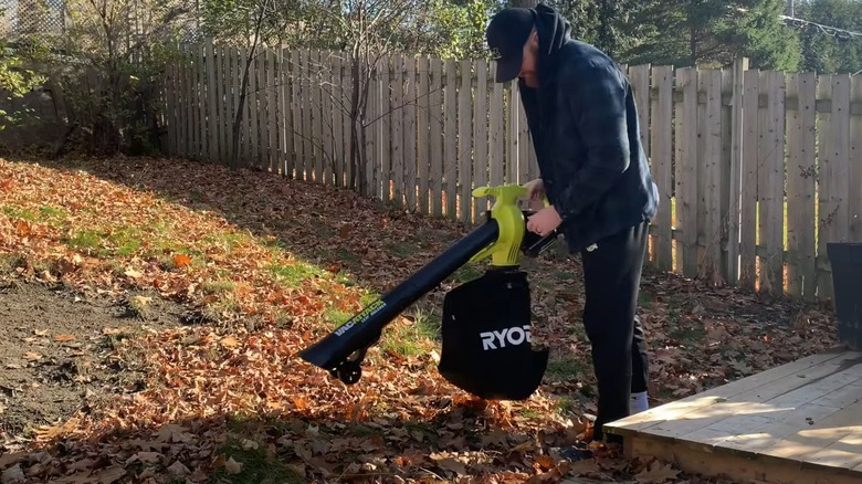 Man using a Ryobi leaf vacuum and mulcher