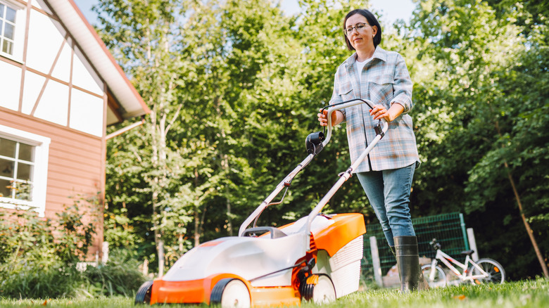 Woman mowing lawn