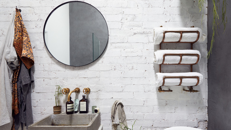 Modern bathroom with towels on rack and hook