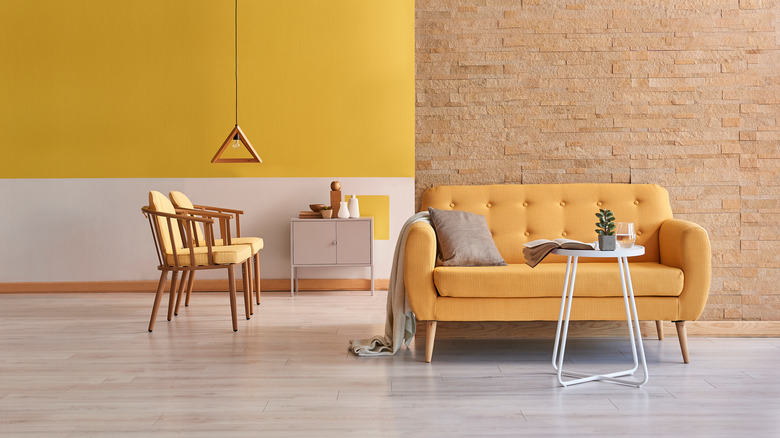 Room with yellow and brick walls