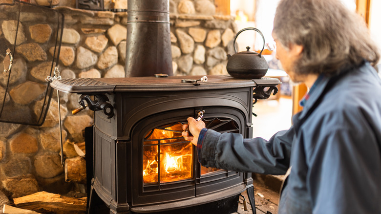 Warming up by wood-burning stove