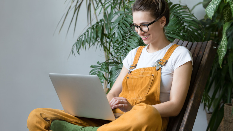 Person is glasses uses laptop