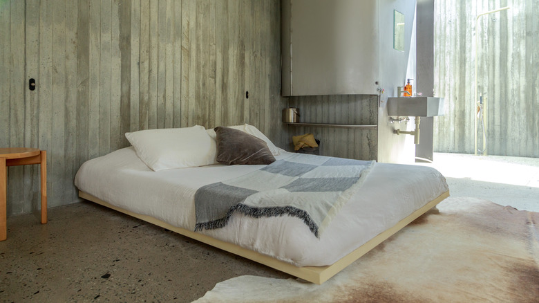 A low bed on a wooden platform.