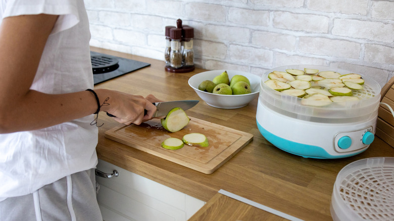Someone slices pears for a dehydrator.