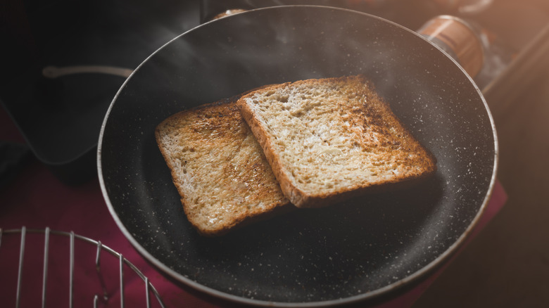 Two slices of toasted bread in a pan.