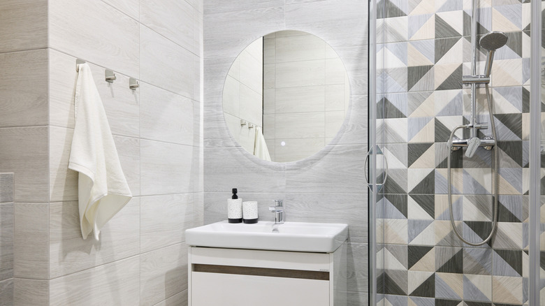 A minimalist bathroom with towels hanging on hooks.
