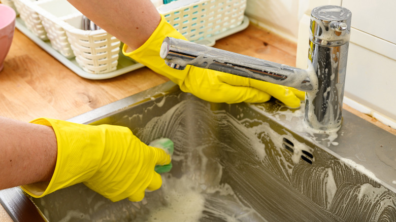 Cleaning sink with a sponge and soap