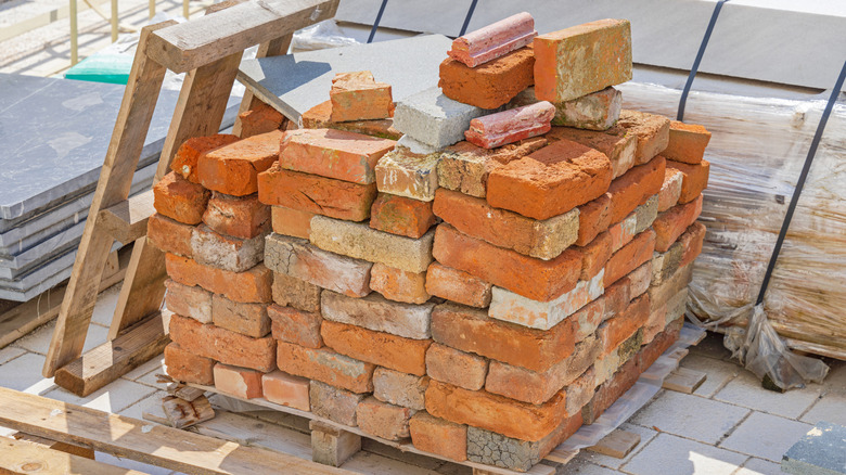A pallet stacked with reclaimed bricks at a building material supply yard