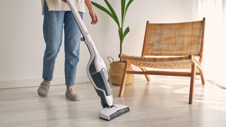 person using a cordless vacuum