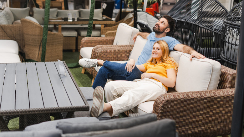 A couple testing a patio furniture set in-store