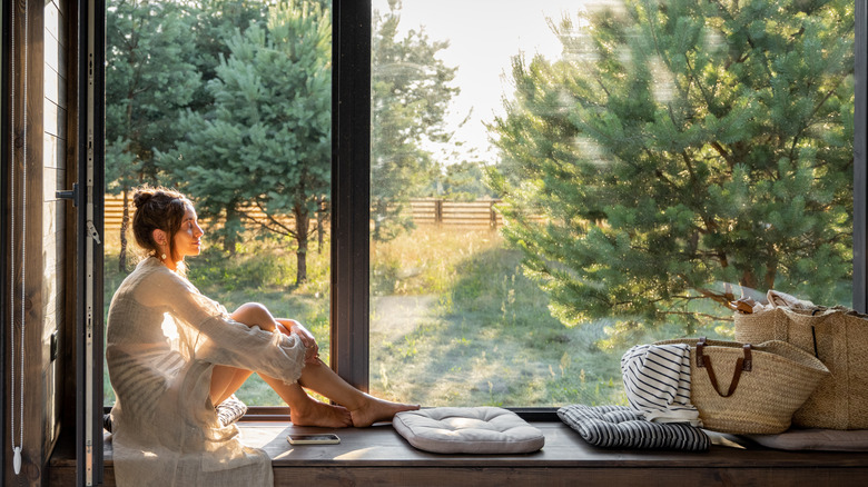 Woman sitting by window
