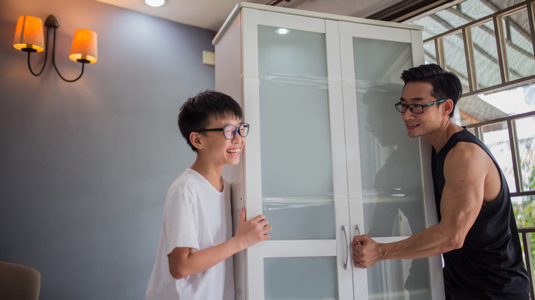 father and son moving cabinet