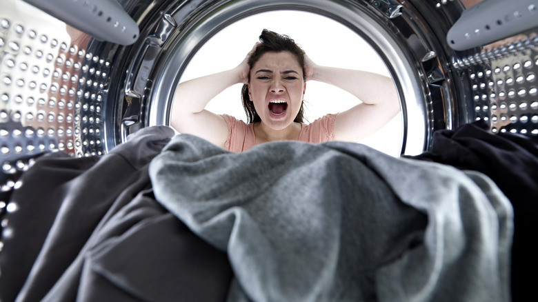 Person screaming at washing machine