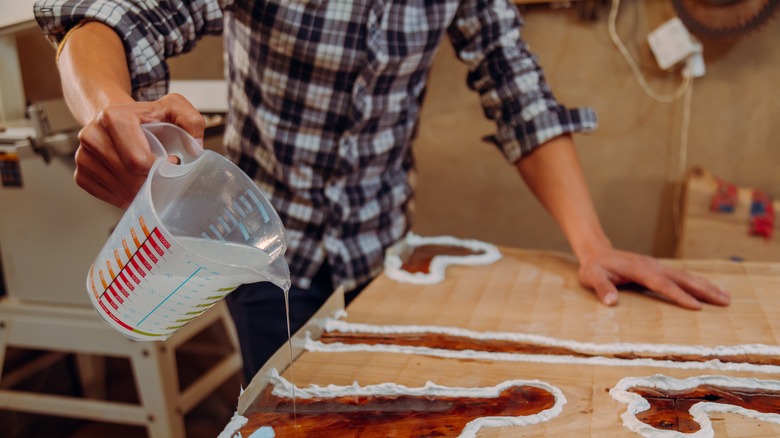 Pouring epoxy resin on table