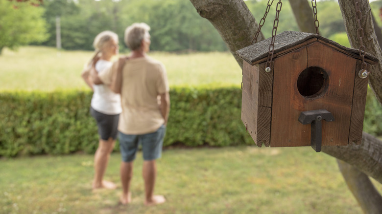 happy couple in yard birdhouse