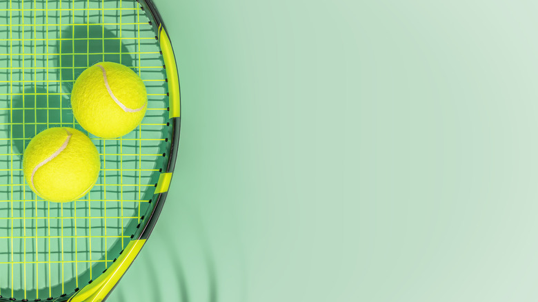 two tennis balls on racket