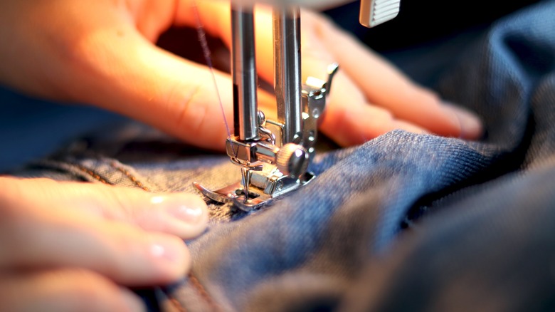 Fixing jeans with sewing machine