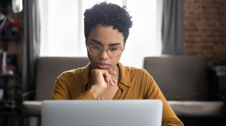 woman working seriously at laptop
