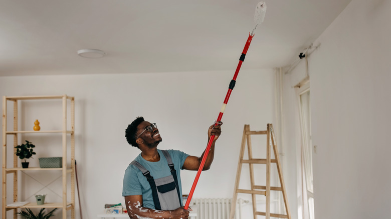 Person painting the ceiling