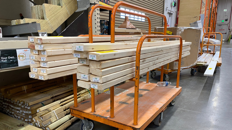2x4 lumber is stacked on an orange cart