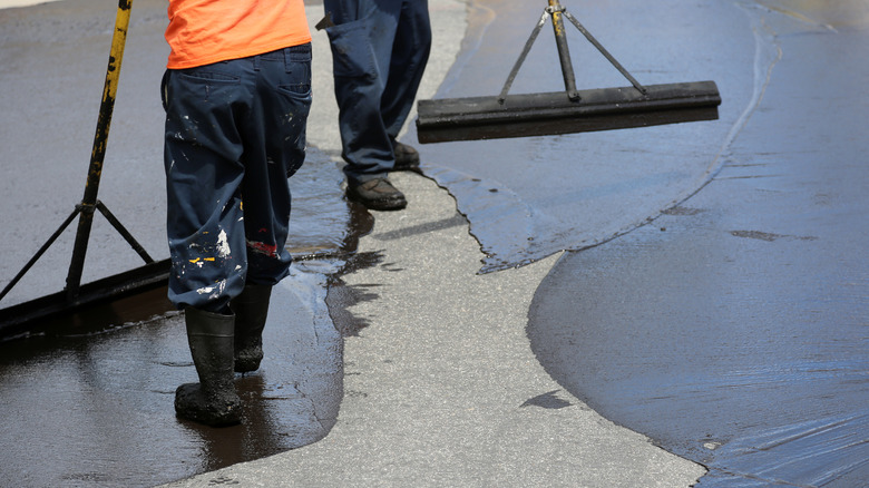 People sealing driveway