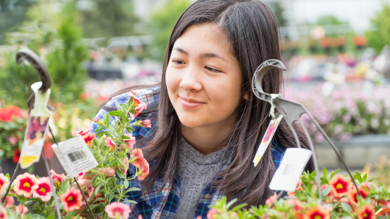 woman examining plant tags