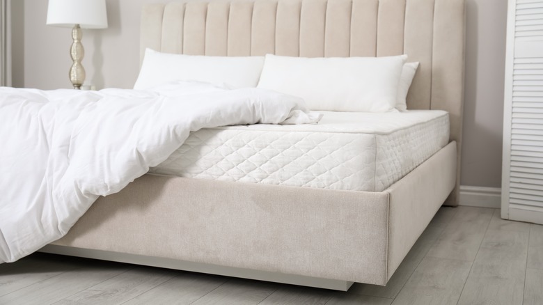 white mattress on cream bed