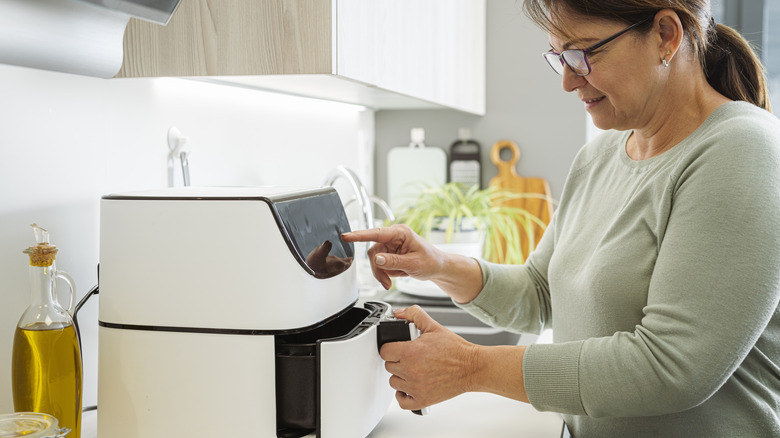 Person using air fryer