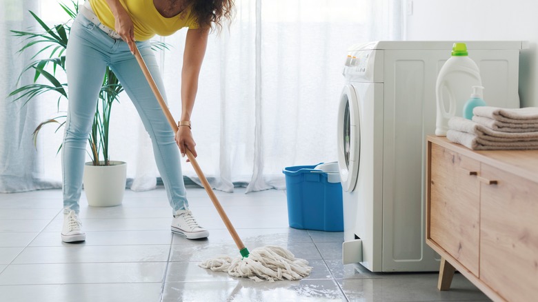 Woman mopping a wet floor