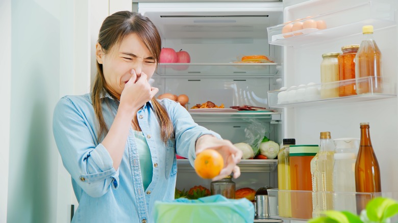 Woman throwing away rotten food
