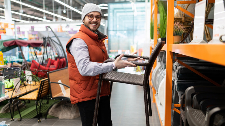 Man in a beanie and vest buying patio furniture